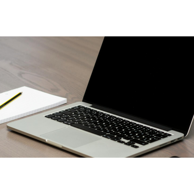 notepad and laptop on a desk