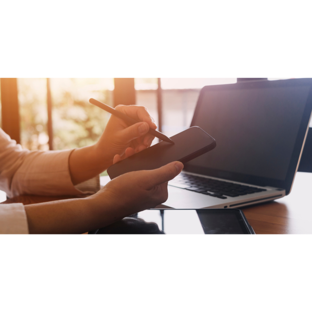 person working with phone and laptop computer